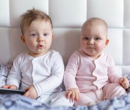babies sititng on bed