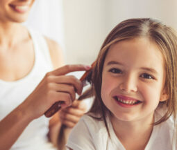 mom combing daughter's hair