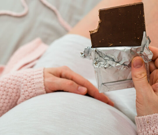 pregnant woman eating chocolate