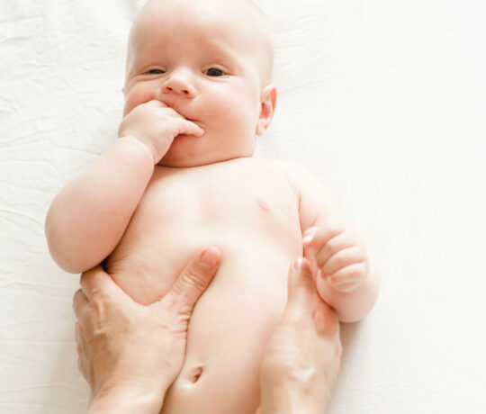 Mom rubbing baby's belly