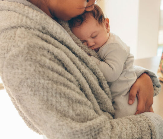mom hugging newborn