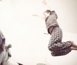 kid jumping on bed