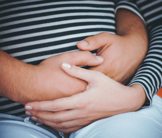 man hugging pregnant woman