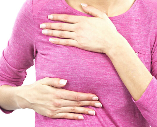 woman self examining breast