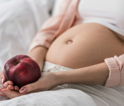 pregnant woman holding apple