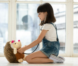 little girl as doctor with stuffed toy