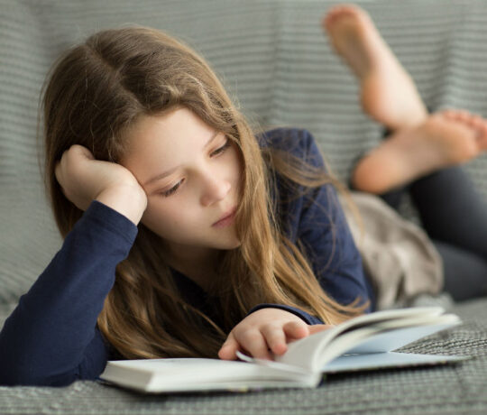 little girl reading a book