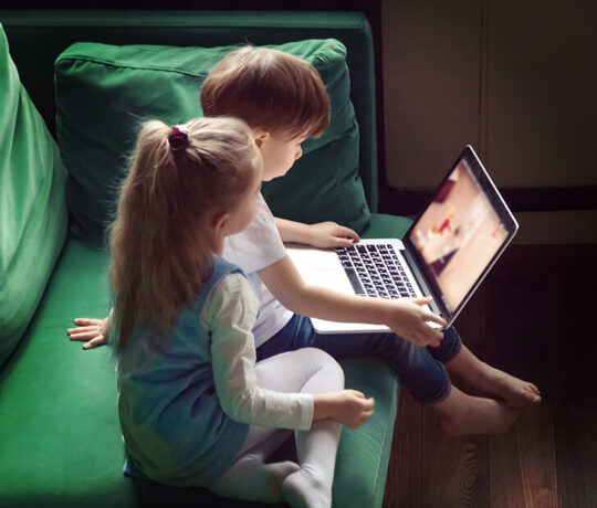 little kids playing on laptop