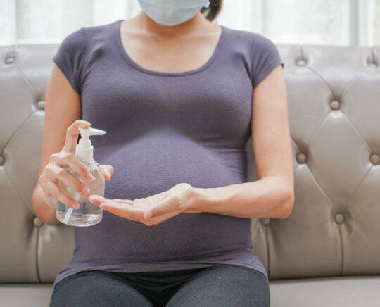 pregnant with mask and antiseptic