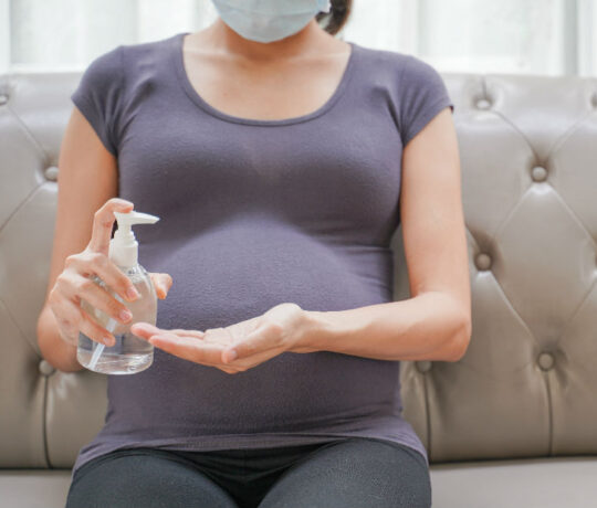 pregnant with mask and antiseptic