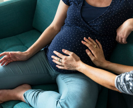 pregnant with belly touched