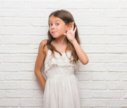little girl tries to listen