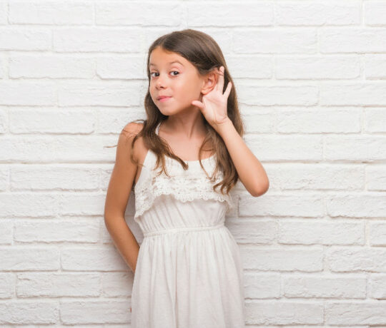 little girl tries to listen