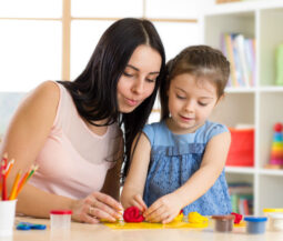 mom and little daughter playing with plasteline