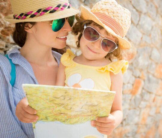 mother and little daughter looking at a map