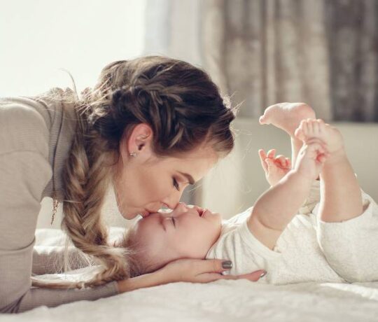 mom with baby kiss