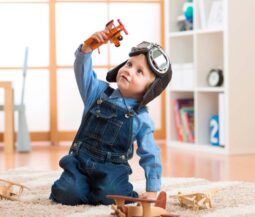 kid playing with little planes