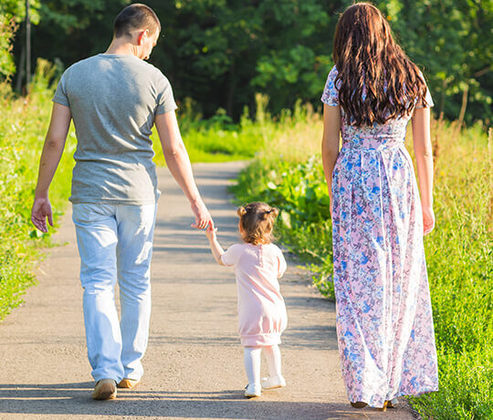 parents with little child for a walk