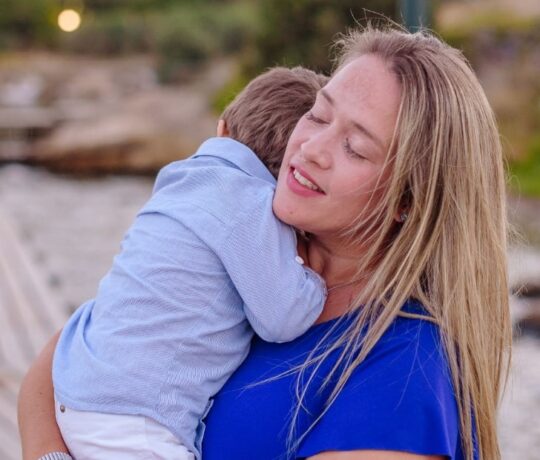 Happy mom cudling her children