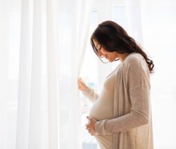 pregnant woman in front of a window