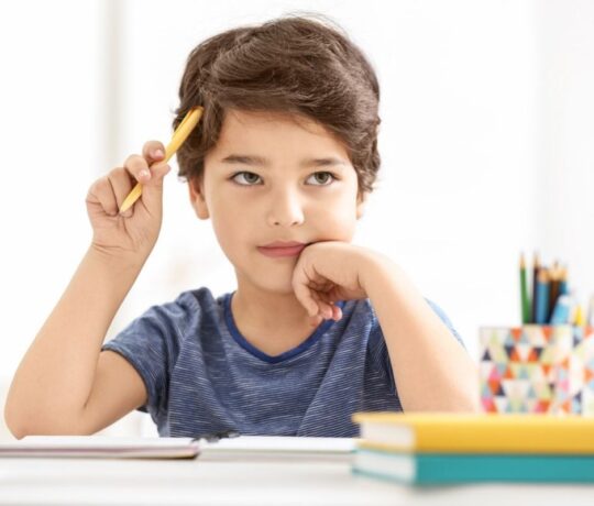 boy thinking at his desk