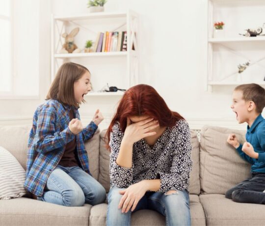 Kids fighting in front of her children