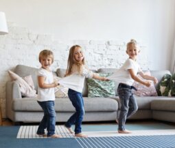 three kids playing in livingroom
