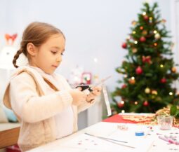 kid decorates christmas tree