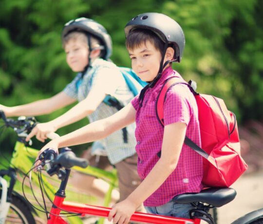 2 kids riding a bicycle