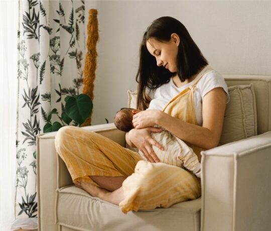 mom breastfeeds her baby