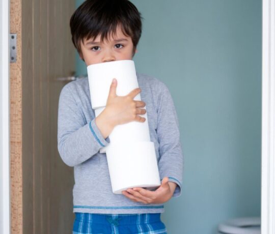 boy with paper towels for the bathroom