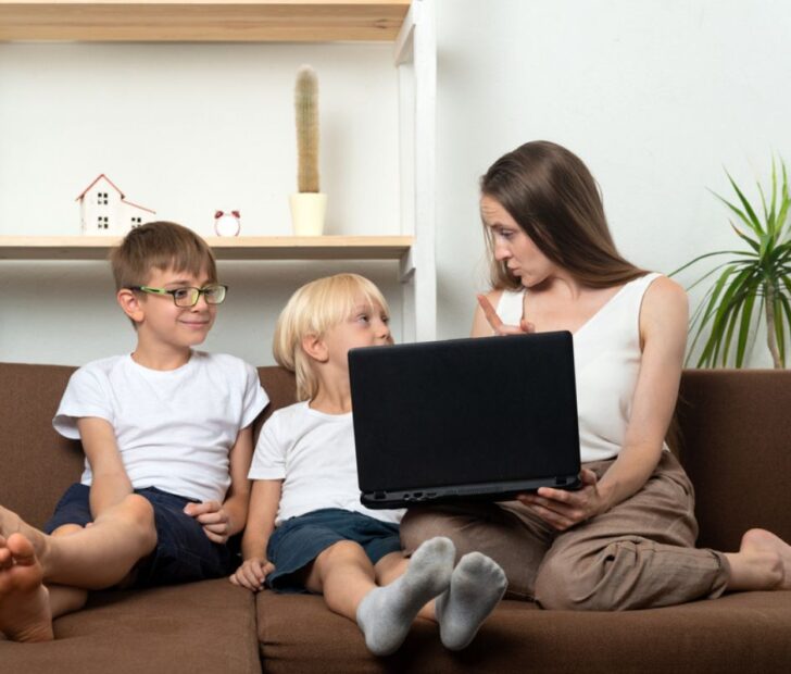 mother with kids on the coutch