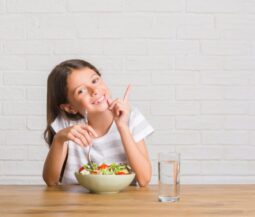 little girl eating healthy food