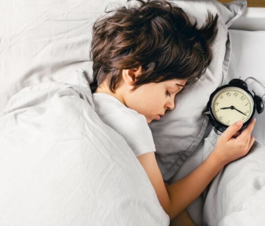 children in bed with watch