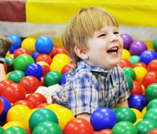kid playing with balls