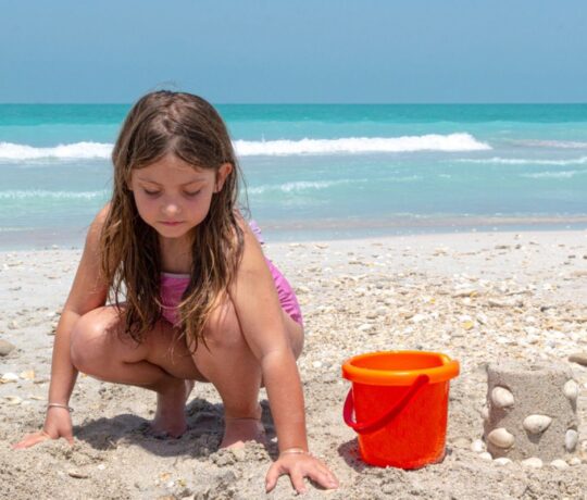 Girl playing by the sea