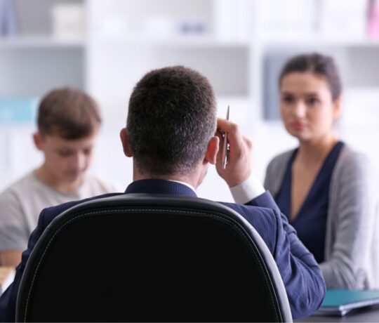 teen with his mom and the principal
