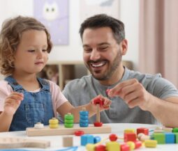 kid with parent playing